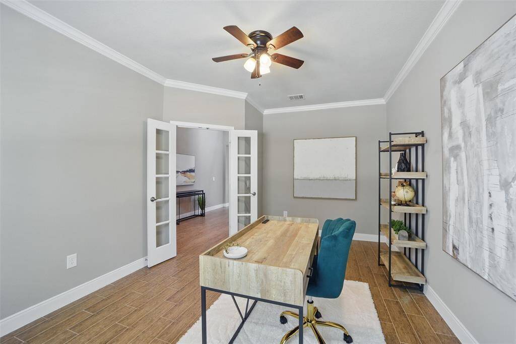 Spacious office with ceiling fan is large enough for two work stations. Or large collectable displays.