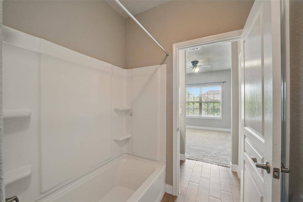 Shared tub/shower and toilet area.