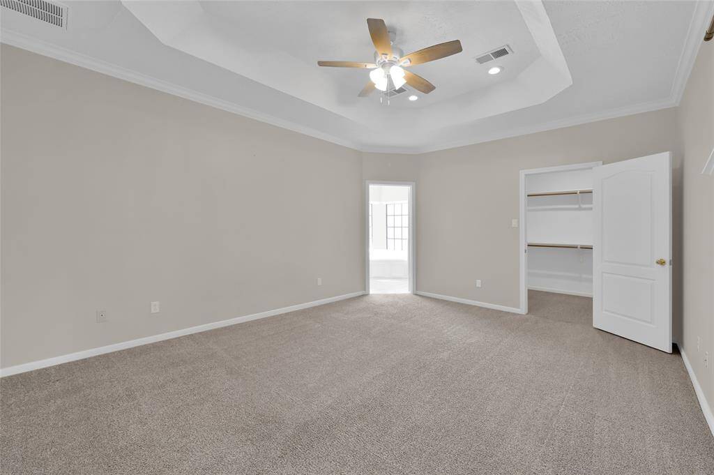 Primary Bedroom with first large walk-in closet and trey ceiling