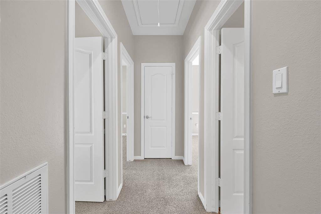 Hallway to 3 secondary bedrooms and bathroom