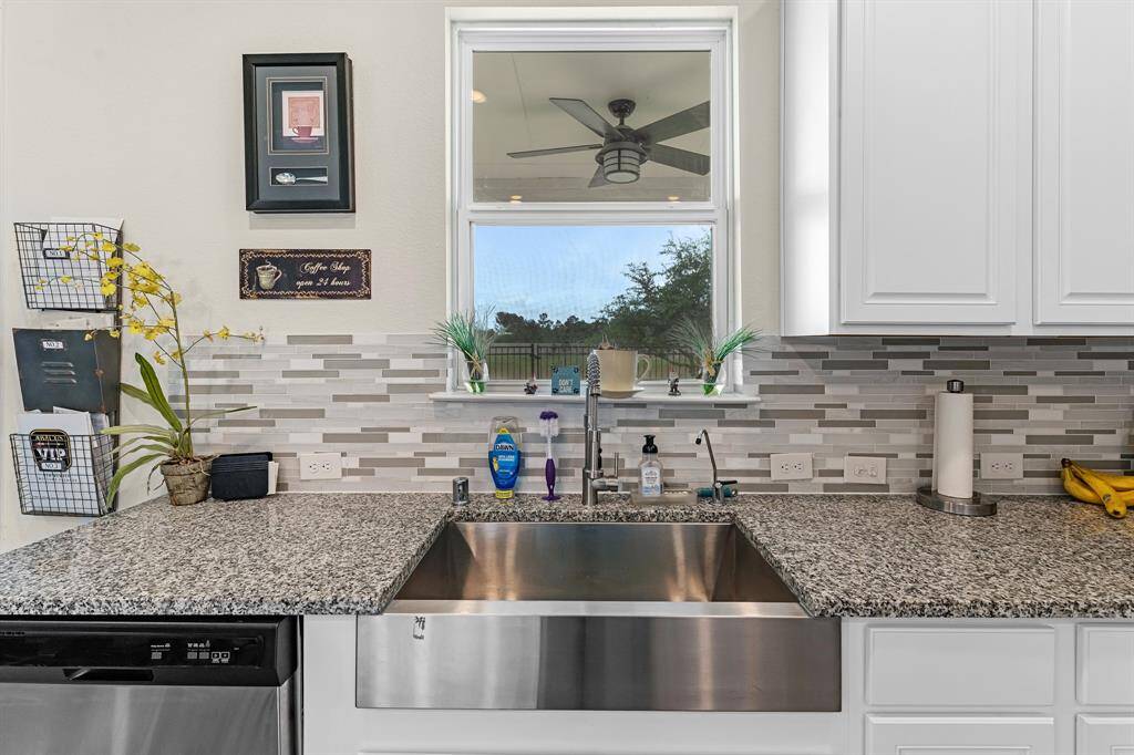 Natural light streams in through this window, providing a view of the gorgeous outdoors.  The sink and faucet have been upgraded too!