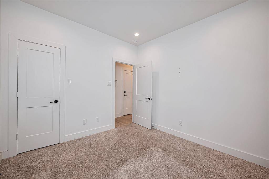 Bright and welcoming, this secondary bedroom offers a clean canvas with soft carpeting, recessed lighting, and a spacious closet—perfect for rest, work, or play.