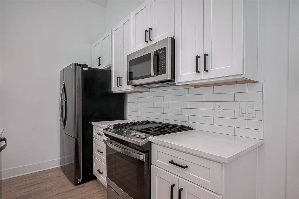 Clean lines and contemporary finishes define this kitchen, complete with stainless steel appliances, shaker-style cabinets, and expansive counter space—crafted for style, storage, and seamless functionality.