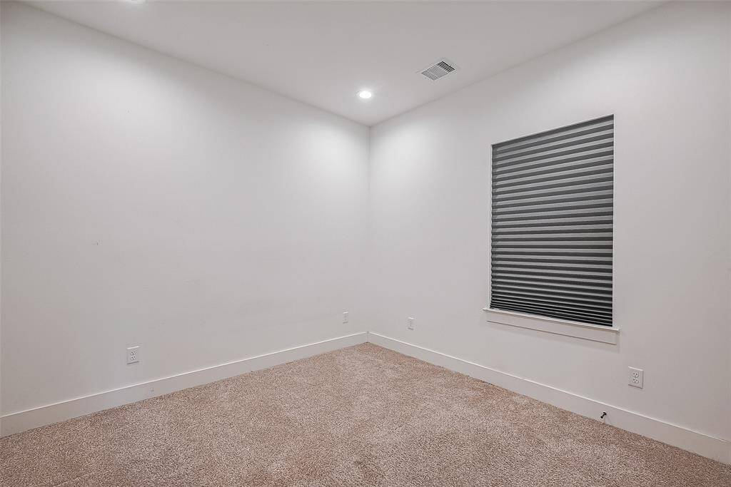 This versatile bedroom offers plush carpeting, recessed lighting, and a neutral palette—ready to become your cozy retreat, home office, or creative space.