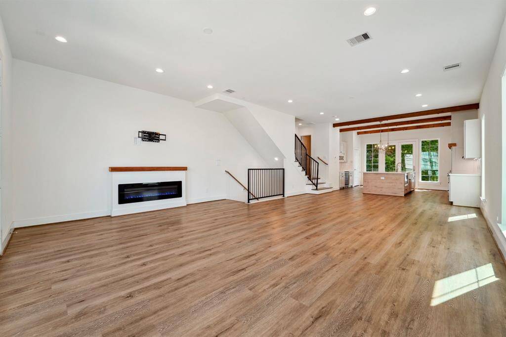 Gorgeous color changing fireplace as the focal point of this very large family room.
