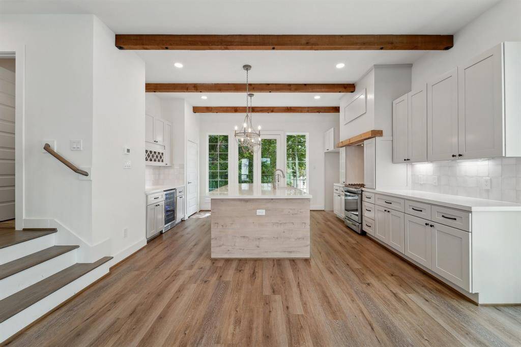 Grand kitchen with large island and breakfast bar.