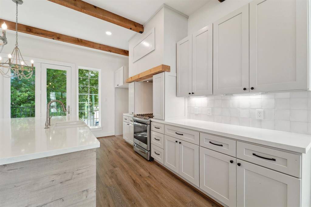 Plenty of shaker style cabinets, and quartz countertops.