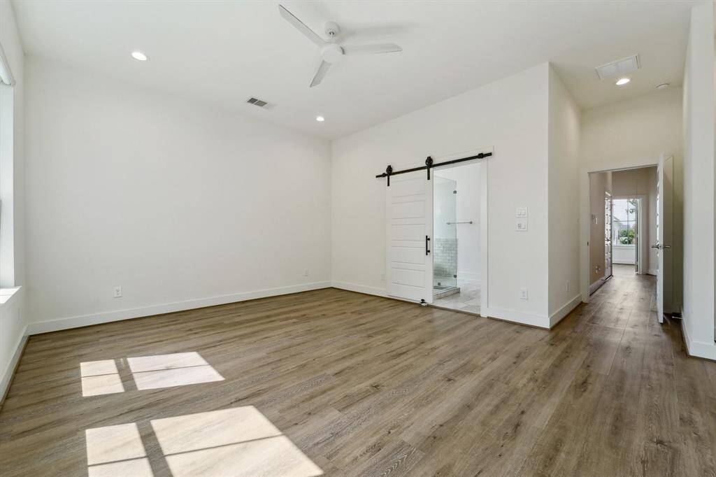 Large primary bedroom with soaring ceilings