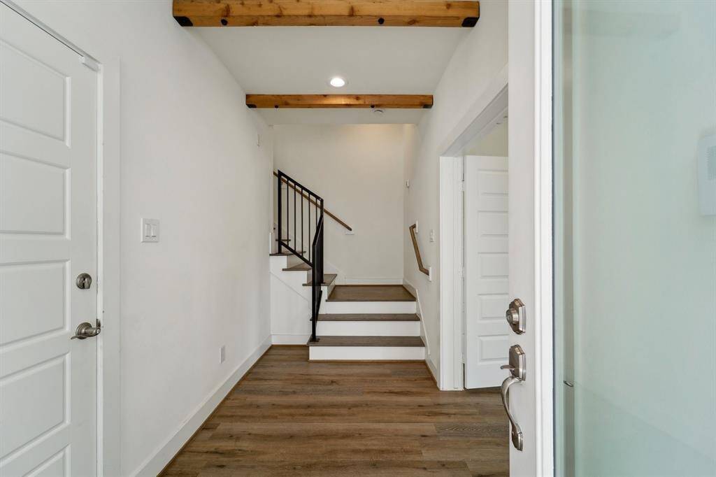 Grand entry with wooden accent beams.