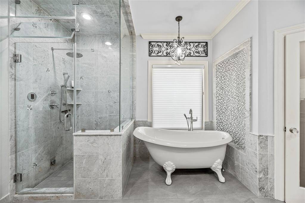 This ensuite offers an classy clawfoot tub and a separate steam walk-in shower with frameless glass and gorgeous tile work.