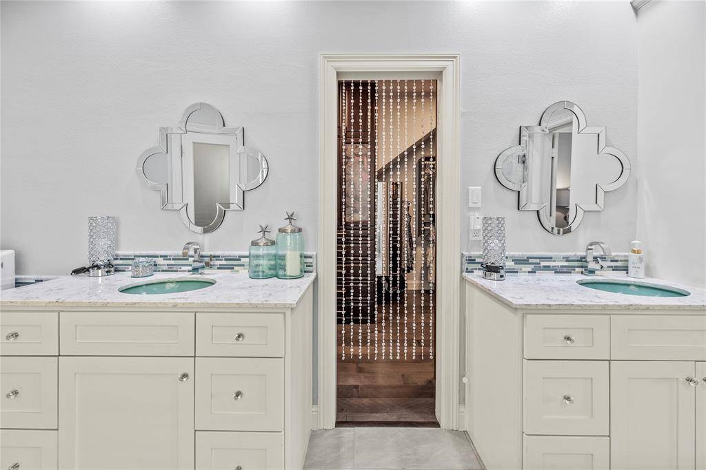 You don't have to share! The double sink vanity and oversized mirror lends itself to harmonious mornings.