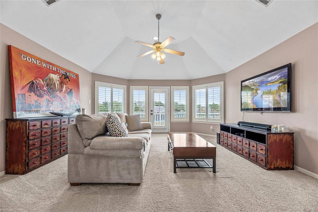 Get the popcorn, it’s movie time! This fabulous game room currently used as a home theater is ready for action with plush carpet, custom paint and a raised ceiling.