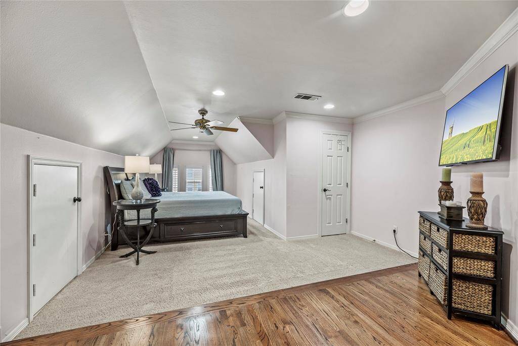 This spacious bedroom was an add on, equipped with an en-suite bath, and walk in attic access for storage!