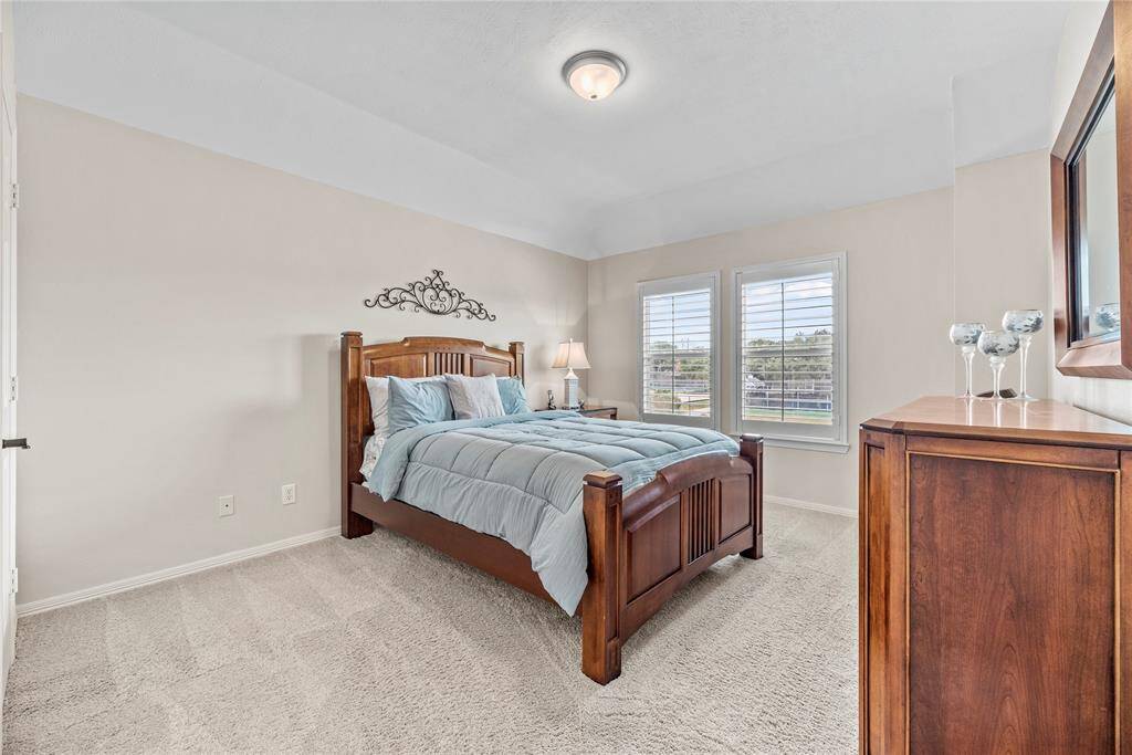 Stretch out and relax in cozy comfort in this secondary bedroom. The light pouring in from the windows makes the space bright and inviting.