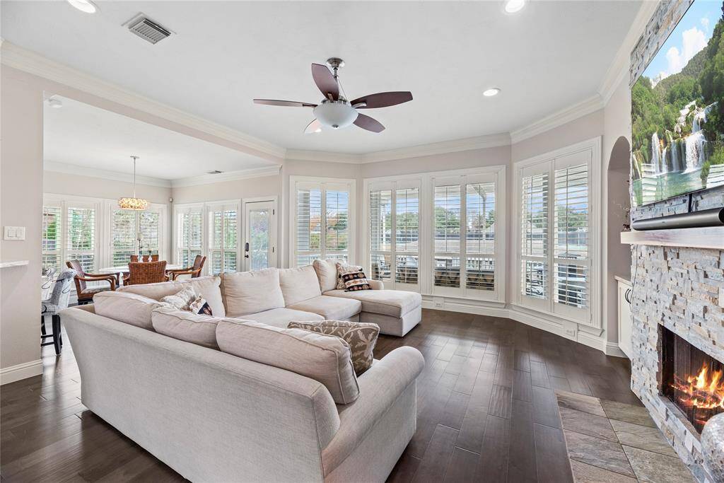 Welcome to the heart of the home, where comfort meets luxury. This family room boasts a wall of windows that allow natural light to flow through the space.