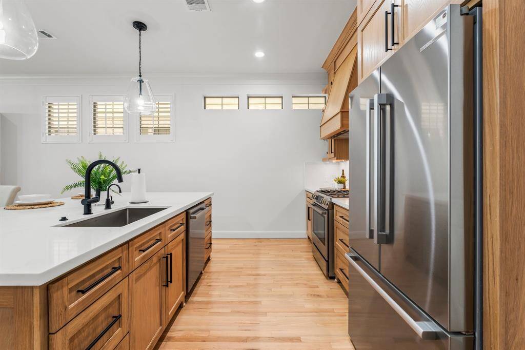 Built in refrigerator surrounded by newly installed custom cabinetry complete with soft close drawers and under counter lighting.