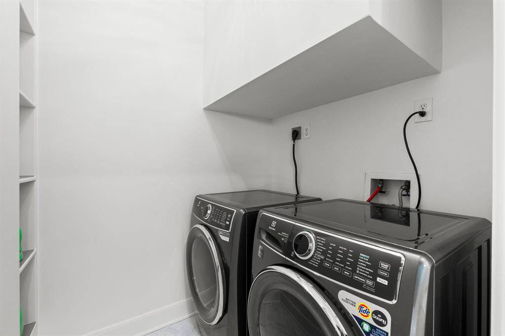 The laundry room is conveniently tucked away on the second floor.