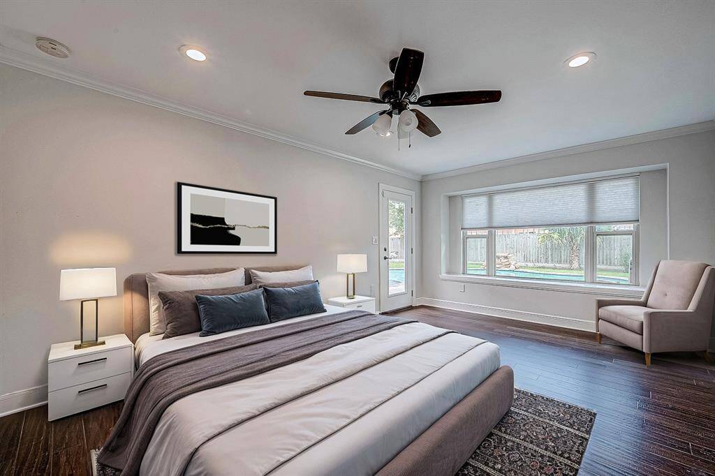 Primary bedroom overlooks the serene and private backyard. *photo virtually staged