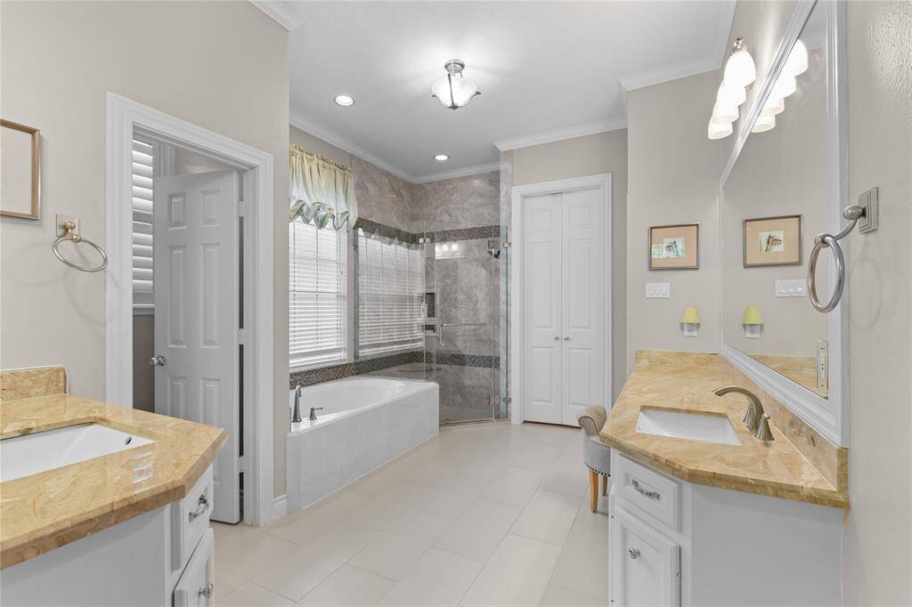 A walk-in closet, dual vanities, Granite countertops, a garden tub and a walk-in shower w/frameless glass door and beautiful tiled interior offering a spacious and elegant