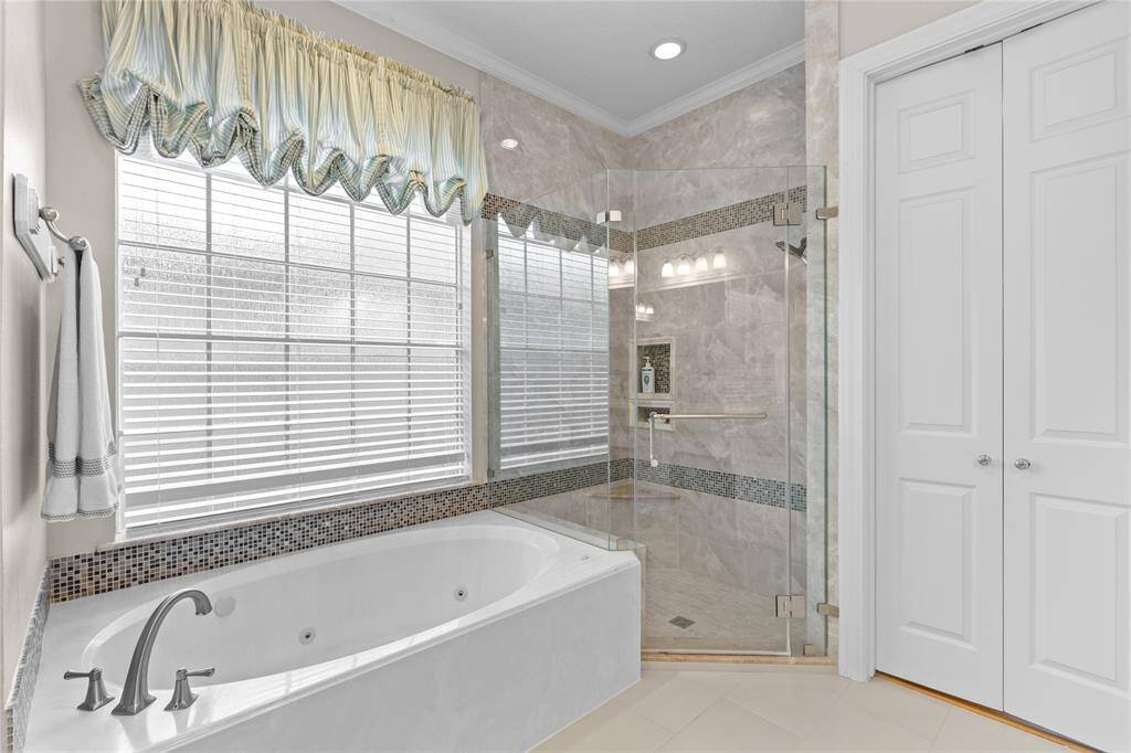 The primary bath feature a large window that bathes the space in natural light.