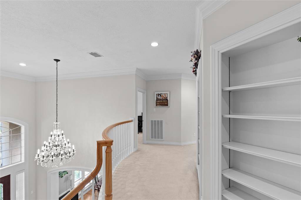 The second floor hallway overlook the grand foyer below