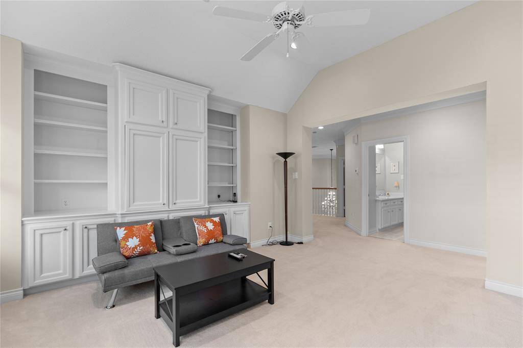 Huge game room upstairs features plenty of built-in shelves and storage, ideal for keeping games, books, and other items neatly organized while providing a functional and fun space for entertainment.