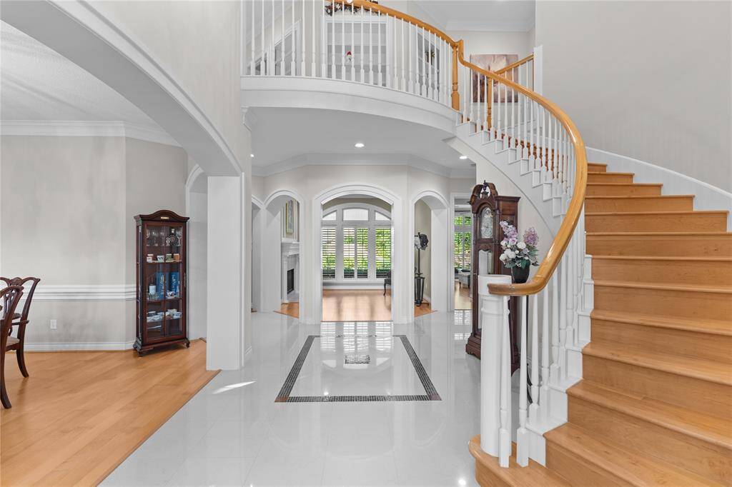 A grand, inviting entrance ushers you into this exquisite home