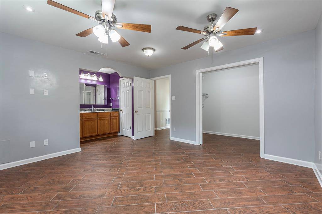 Large closet space and vanity open to the bedroom.