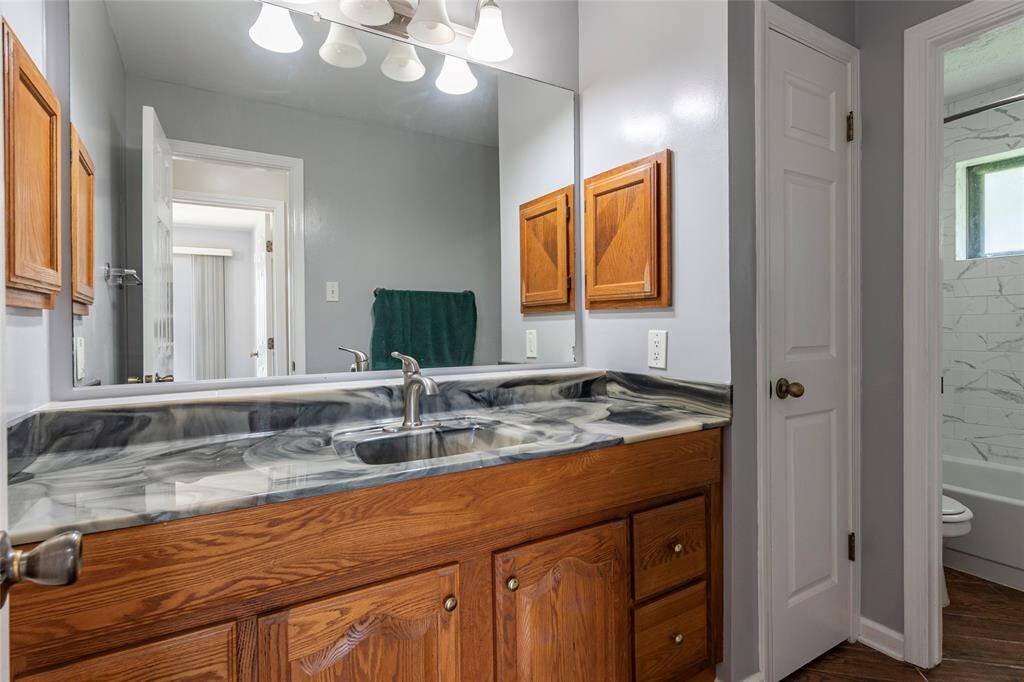 Full sized spare bath with large vanity area and shower/tub combo.