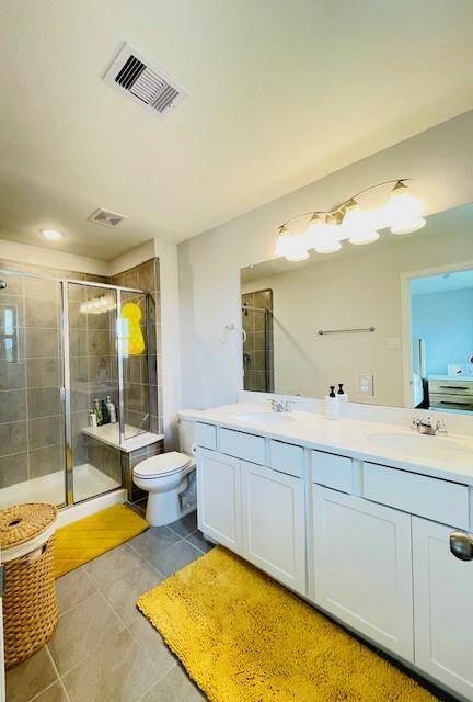 Primary bathroom with dual sink and the shower is large and modern