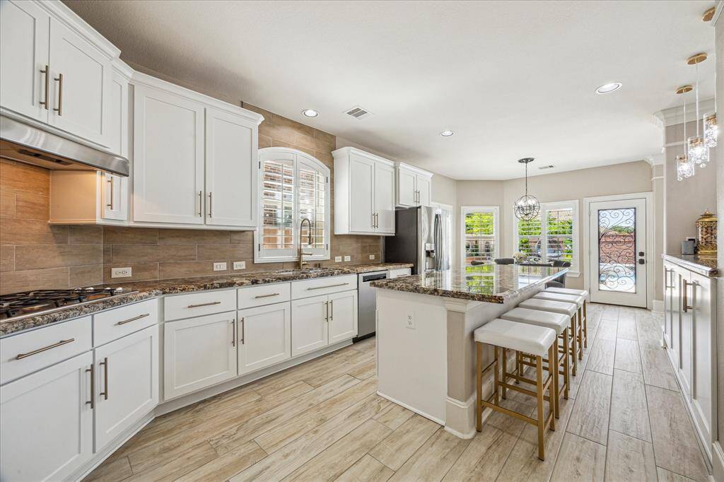 This open-plan layout flows effortlessly into the kitchen and dining area, creating a spacious and connected living space.