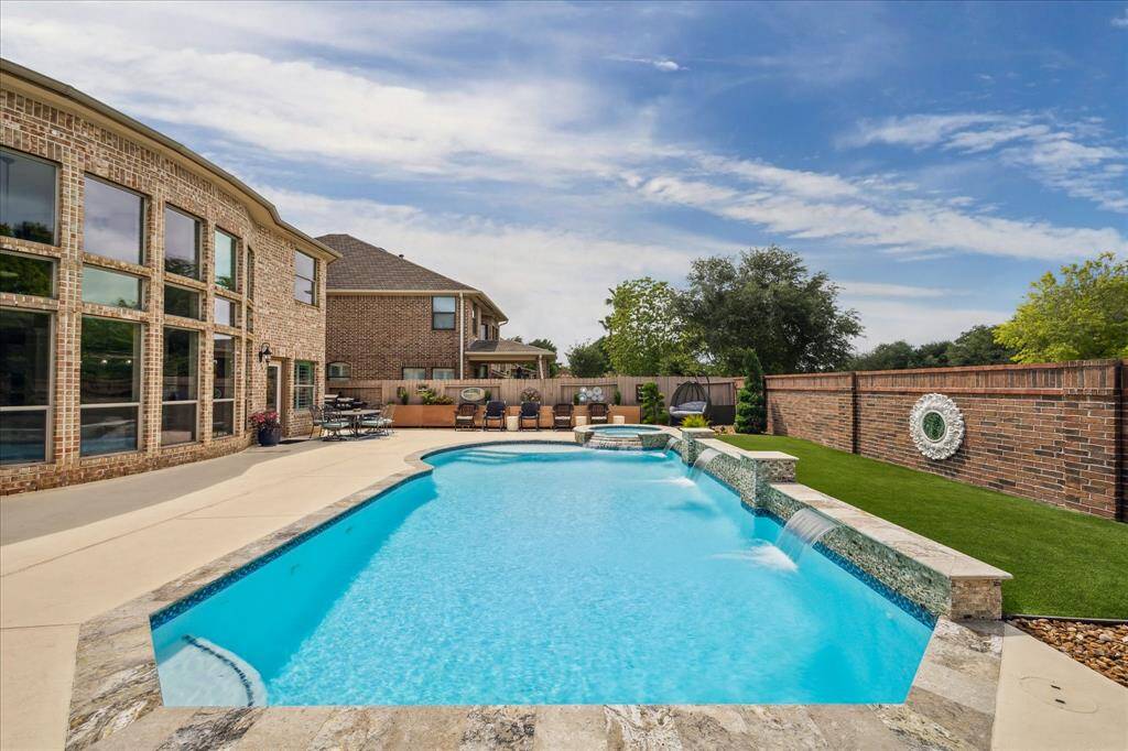 Aerial view of the home’s private backyard shows a solid brick wall and no rear neighbors, offering added privacy and seclusion.