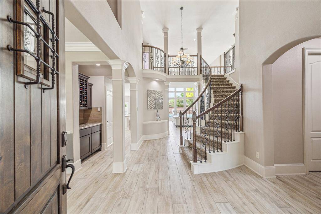 This versatile space can serve as an extra living area or formal dining/sitting room. This area is accented with crown/chair molding and plantation shutters, it's perfect for a music room or cozy sitting area.