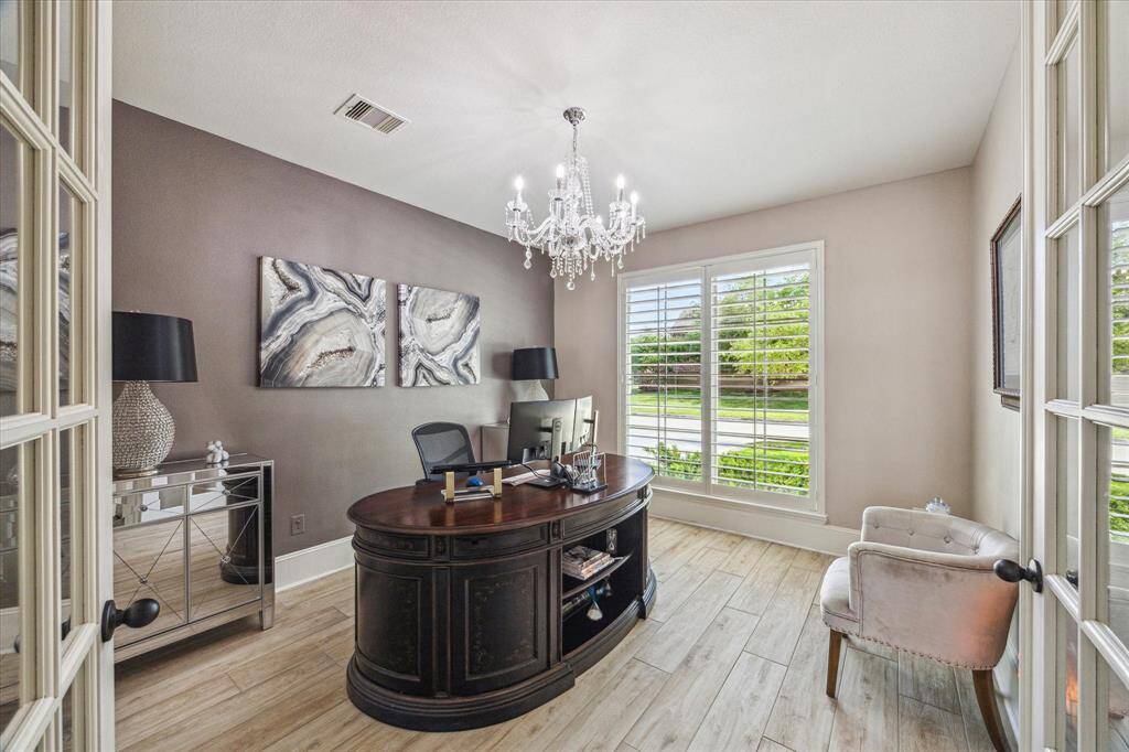 This versatile space can serve as an extra living area or formal dining/sitting room. This area is accented with crown/chair molding and plantation shutters, it's perfect for a music room or cozy sitting area.