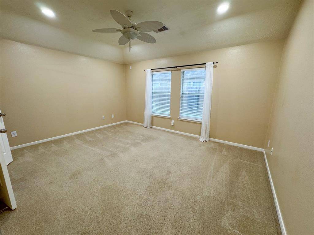 Primary suite off the back of the home offers privacy and easily fits a king size bed and large furniture.