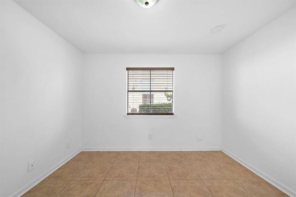 The master bedroom has Fresh Paint, neutral Ceramic Tile flooring throughout, a Large Window with nice Wooden Blinds that let in lots of natural light when open, Large Walk-in Closet, and modern fixtures and finishes!!