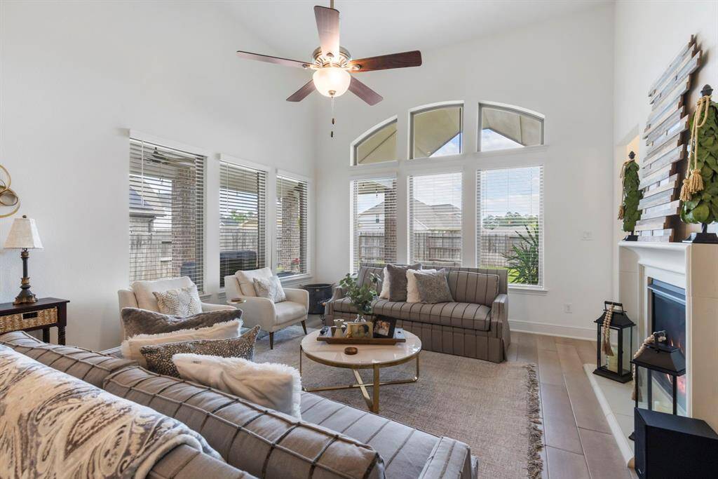 Soft neutral tones on the walls and flooring create an airy atmosphere, while the open layout invites a space for family gatherings .