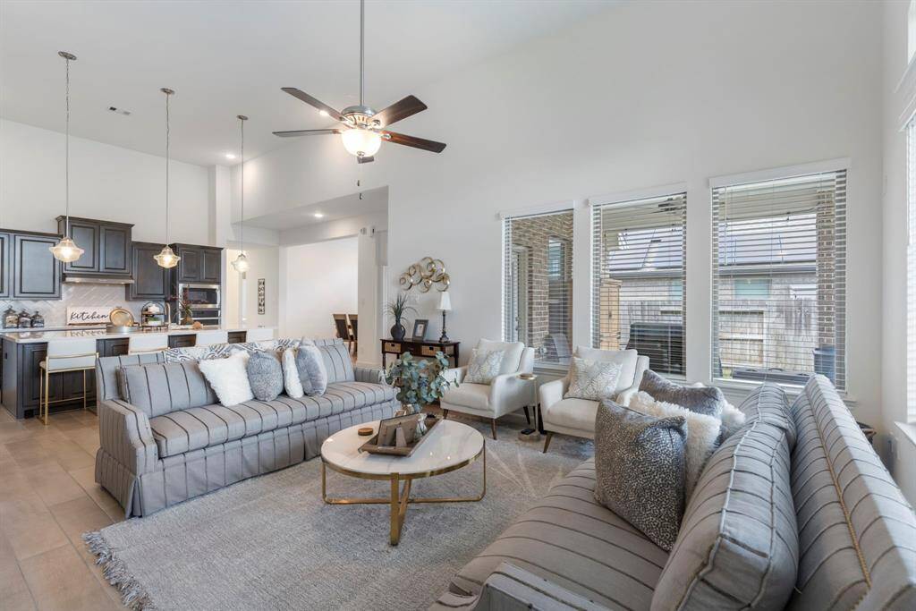 High ceilings and recessed lighting further enhance the room's spacious feel.