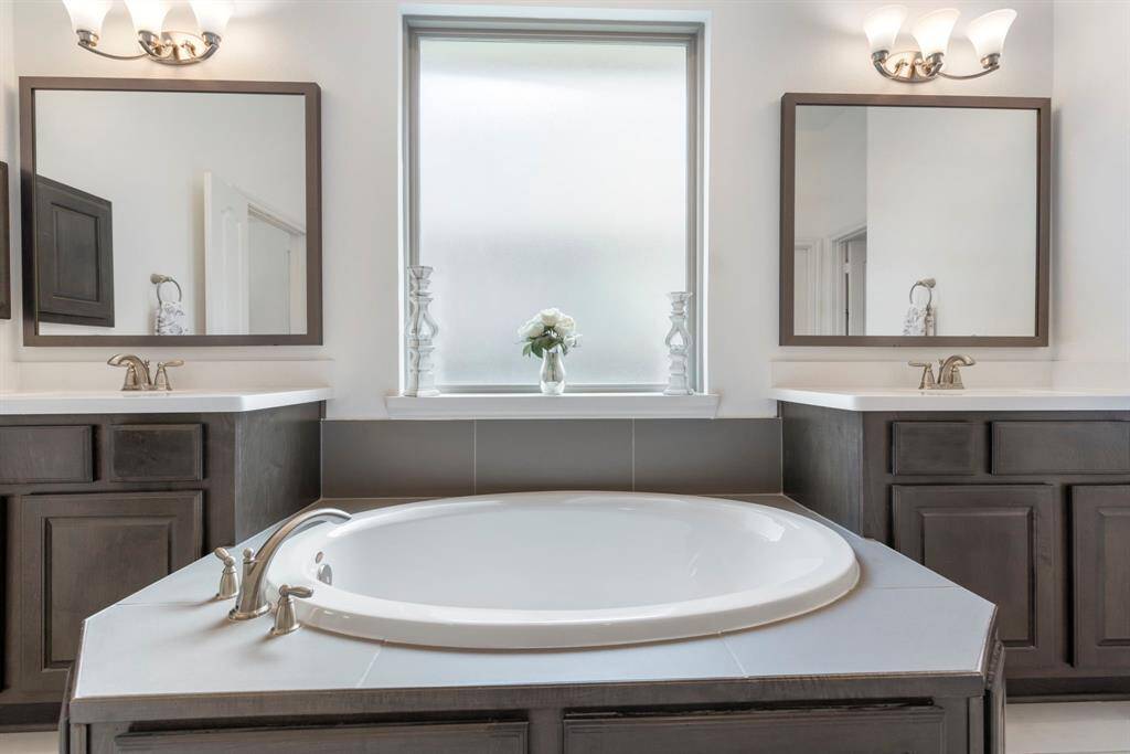Elegant finishes, including sleek tiles and modern fixtures, complement the serene ambiance, making this bathroom a wonderful blend of function and relaxation.