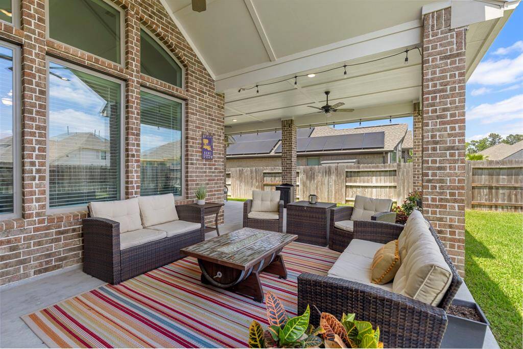 The combination of the stylish patio and vast open yard crates a seamless connection between indoor and outdoor living.