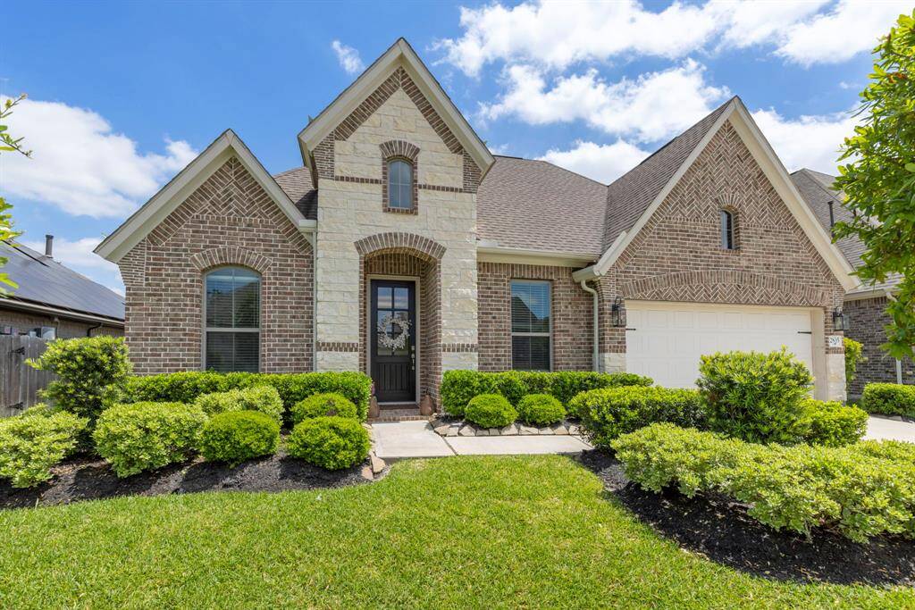 The classic exterior features modern details, with large windows that allow natural light into the home.
