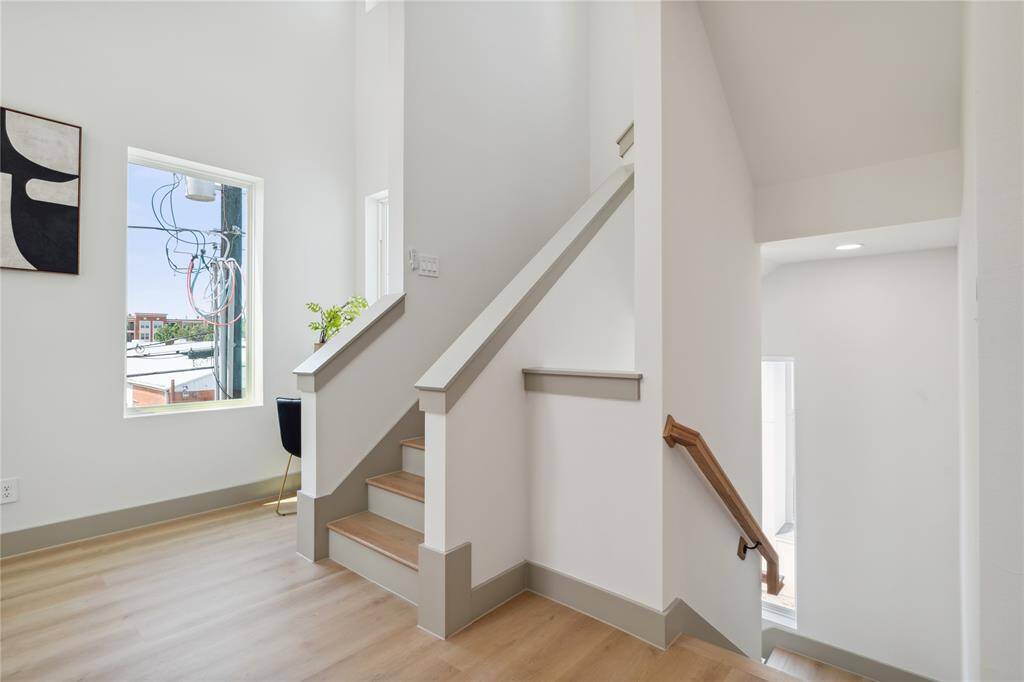 Elevated baseboards and soft neutral hues add depth and dimension to this light-filled vertical connection.