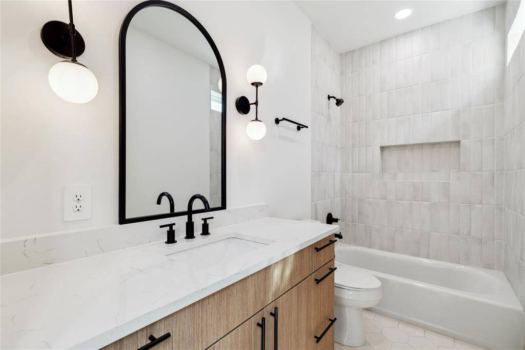 Soft light and timeless finishes make this bath feel serene and smart—perfect for guests or everyday use.