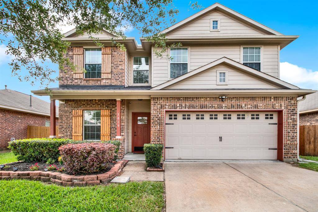 In a peaceful suburban setting, this welcoming two-story home makes a lasting first impression with its classic brick exterior and thoughtfully crafted wooden shutters