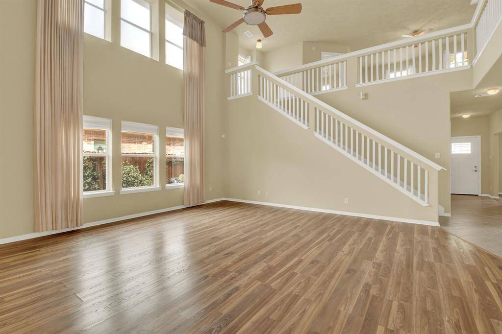 A gently rising California staircase adds architectural interest and connects the main living spaces, creating a natural flow throughout the home.