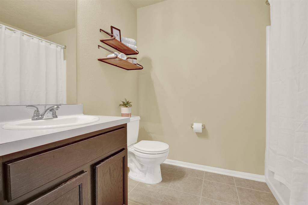 The centrally located bathroom upstairs provides easy access for both the loft area and surrounding bedrooms, offering practical convenience for daily routines and shared use. Its placement ensures functionality without disrupting the layout or flow of the upstairs living space.