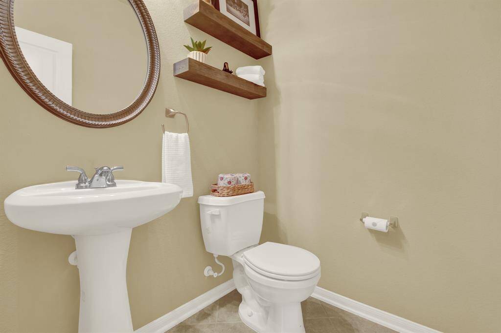 The half bath offers added convenience, providing an accessible space for guests without having to enter the private areas of the home.