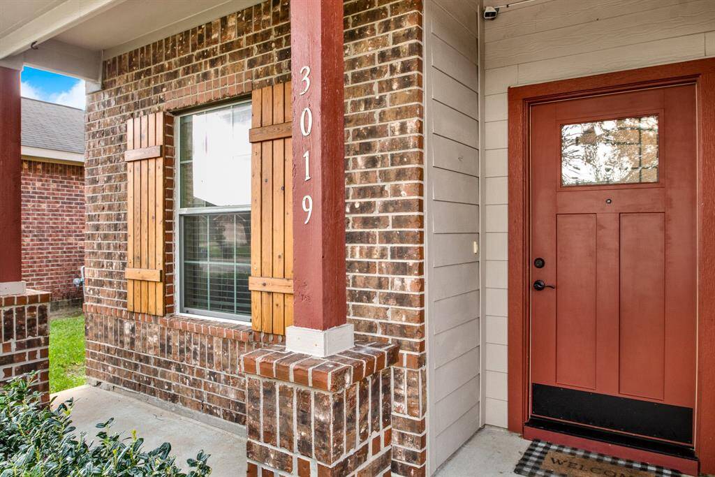 The front porch invites morning coffee and quiet conversation, offering a warm, approachable presence.