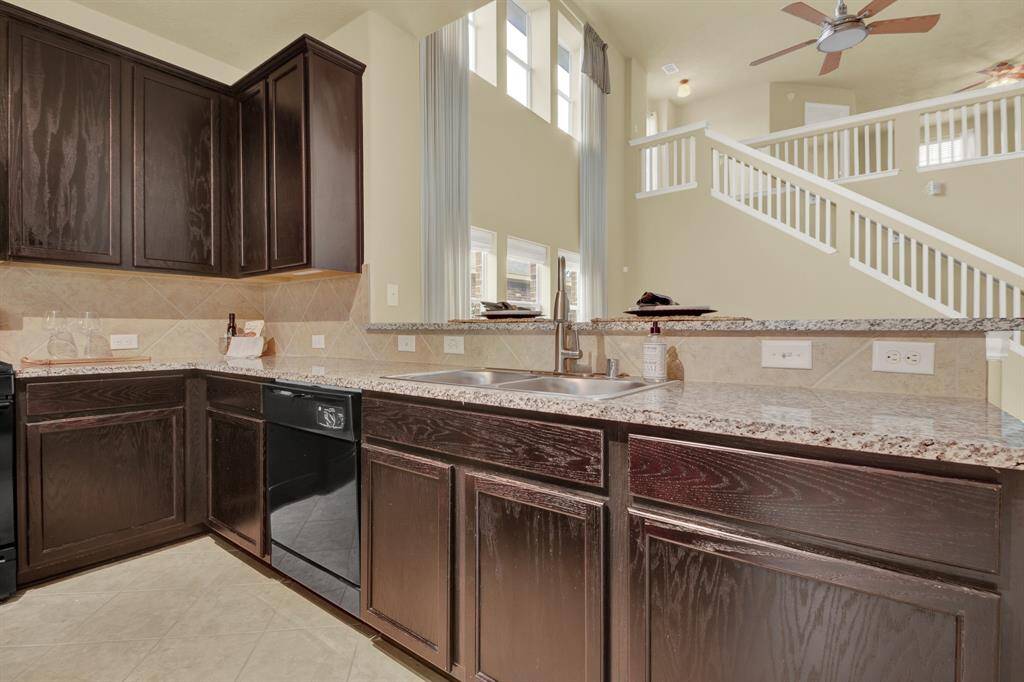 The cabinetry brings a sense of depth and refinement to the space, with a smooth, espresso-toned finish that complements the surrounding features.