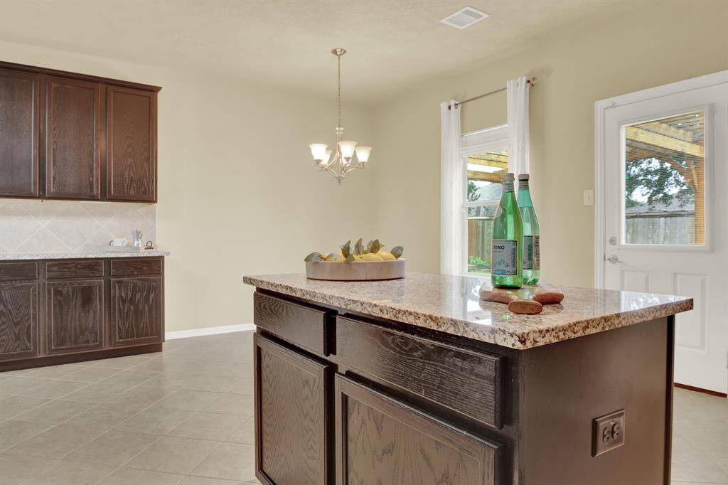 At the center of the kitchen, a generously sized island stands as  a practical workspace